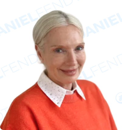 Smiling woman in an orange sweater and white collar.