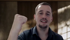 Smiling man raising a fist in celebration