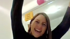 Happy person celebrating with arms raised.