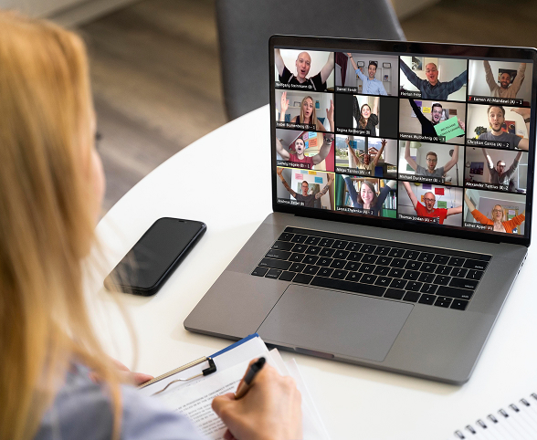 Person attending a video conference with multiple participants.