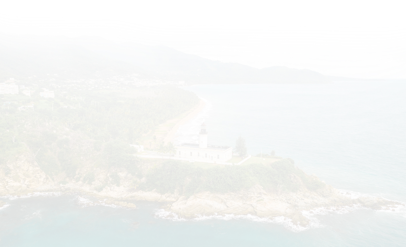 Scenic view of coastline with lighthouse