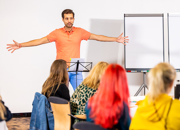 Presenter engaging audience in a workshop setting.