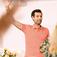 Man greeting audience with raised hand