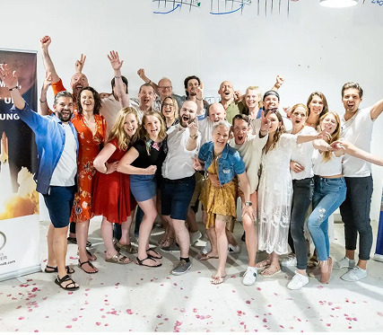Group celebration with joyful participants posing together.