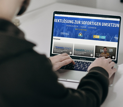 Person using laptop with marketing content displayed