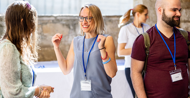 Three people engaging at a networking event.