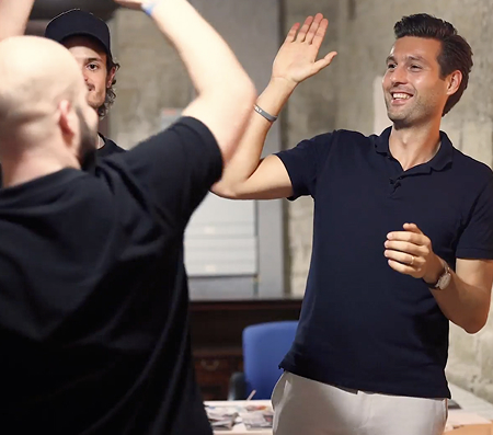 Two men celebrating in an indoor setting.